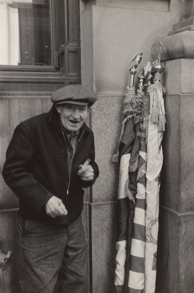 St. Patrick's Day Parade (Old Man standing in corner next to flags)