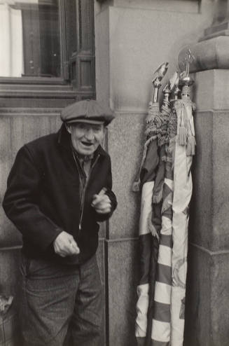 St. Patrick's Day Parade (Old Man standing in corner next to flags)